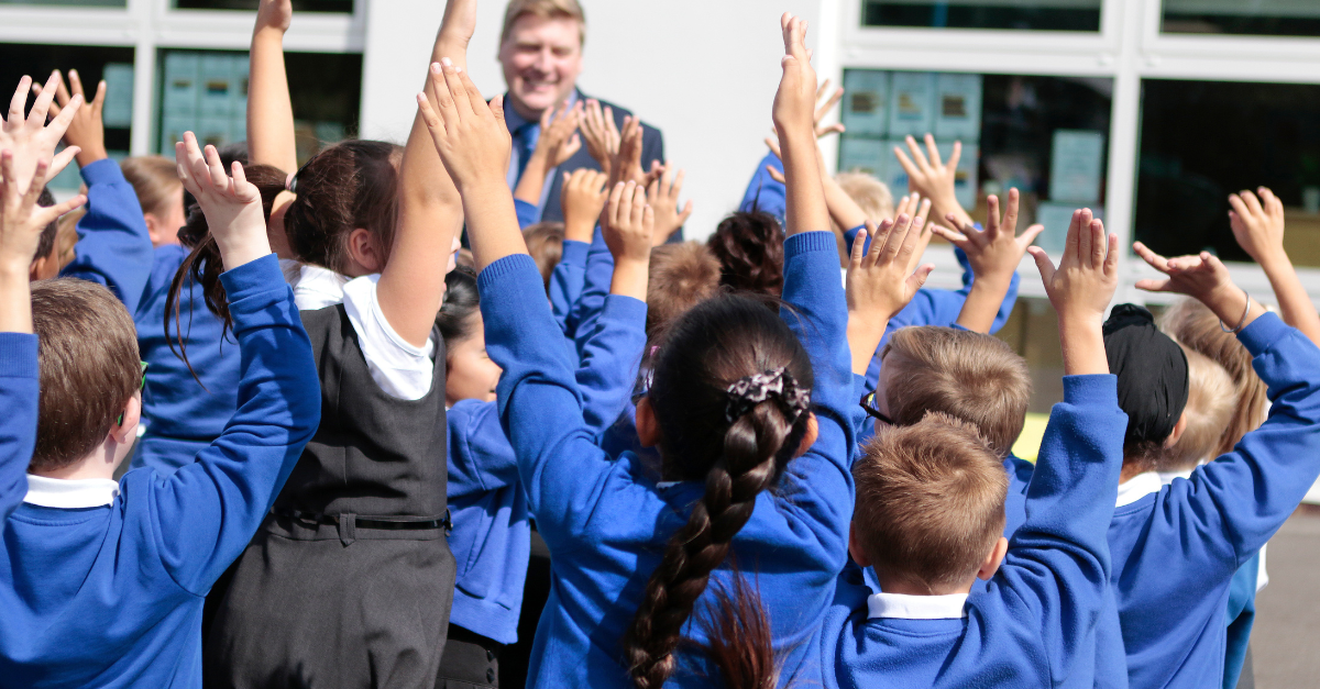 Pupils waving their arms in the air